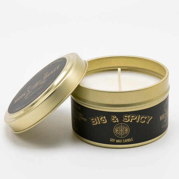 apple cinnamon clove big and spicy soy candle in gold tin on white background, gold lid is off and leaning on tin, black and gold label has sacred geometry design and reads big and spicy soy wax candle