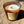 Load image into Gallery viewer, bonfire on the beach soy wax candle with wood wick in amber glass tumbler jar on sandy beach