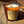 Load image into Gallery viewer, bonfire on the beach soy wax candle with wood wick in amber glass tumbler jar on sandy beach