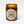 Load image into Gallery viewer, babycake soy candle with cotton wick burning in amber apothecary jar on white background circle kraft paper label design has crossed arrows and reads Babycake NYC wooly beast soy wax candle handmade in portland,  or