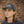 Load image into Gallery viewer, Portland Oregon Hat in grey wool on male model with shoulder length hair against vintage brick background