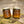 Load image into Gallery viewer, the woodsman scented soy candle laser engraved nordic runes design in amber glass jars with gold lids sitting on mossy log
